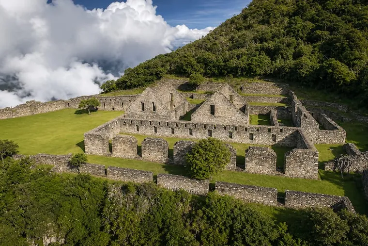 Plazas and roofless stone buildings of Choquequirao among the clouds