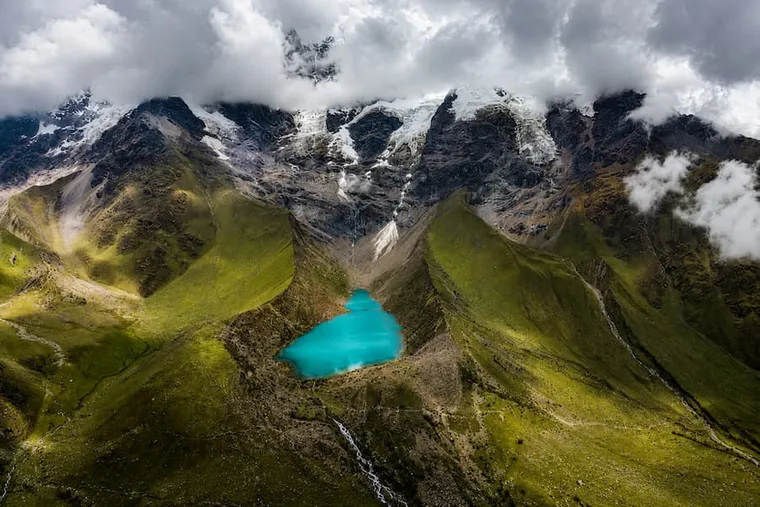 Humantay Lake from the air, bright turquoise below the glacier