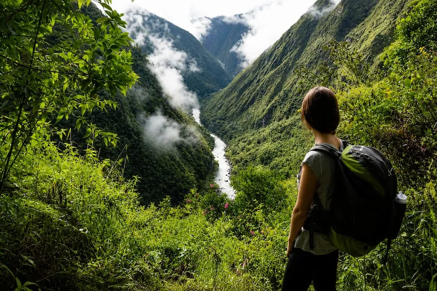 Hiker looking over the misty Urubamba canyon from the Short Inca Trail