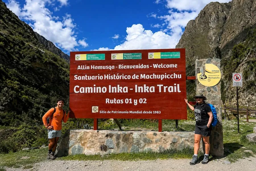 Hikers at the Km 82 sign that marks the start of the Inca Trail