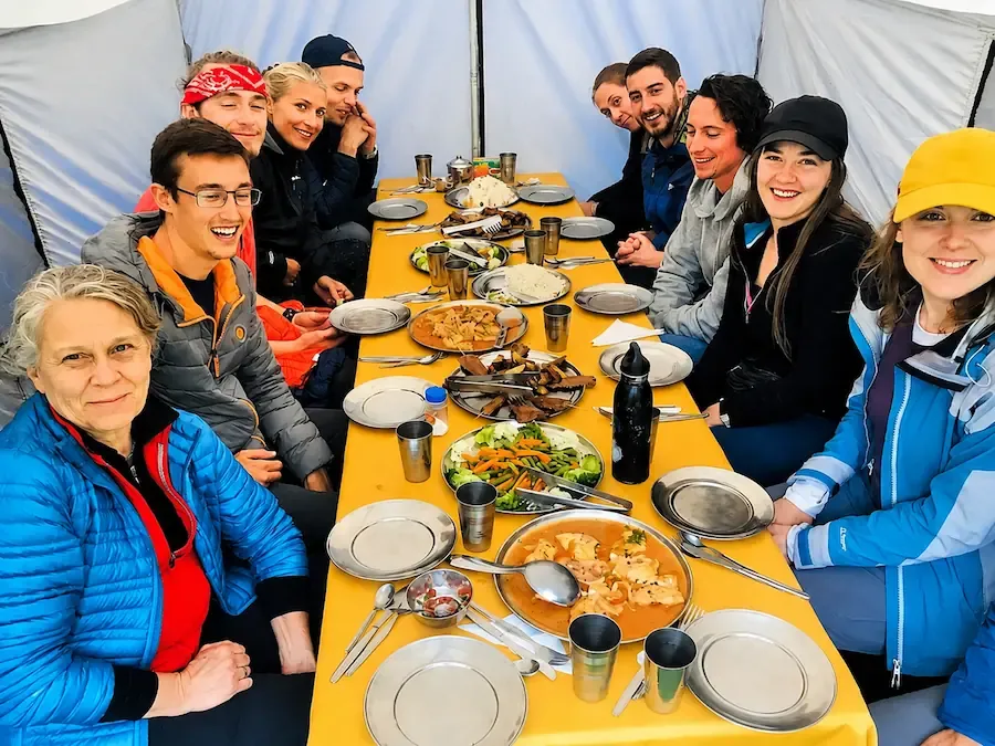 Trekking group eating together in the dining tent
