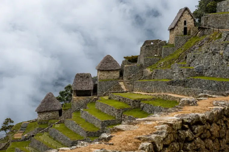 Thatched stone houses on the terraced slopes of Machu Picchu