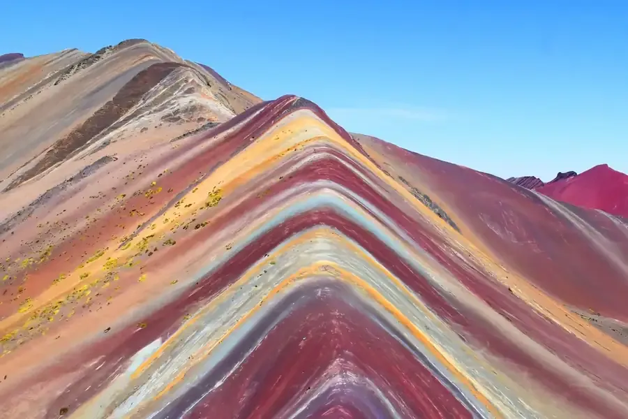 The striped slopes of Rainbow Mountain under a clear sky