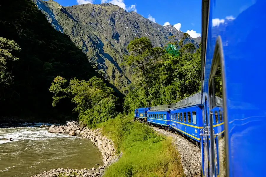 Blue train following the Urubamba river toward Machu Picchu