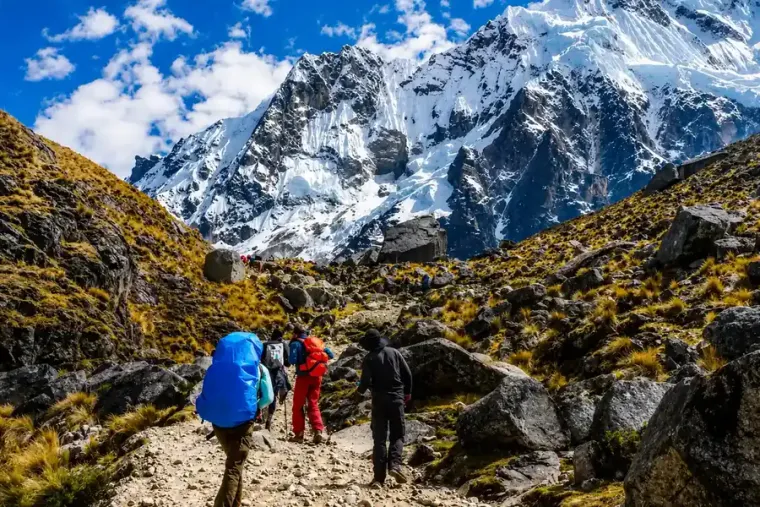 Hikers walking toward the snow covered face of Salkantay