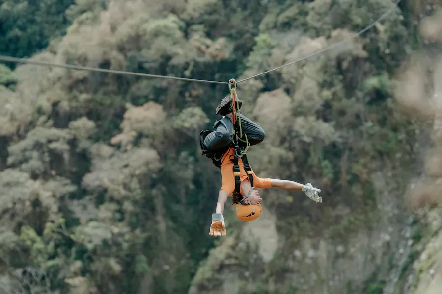 Hiker riding a zipline above the cloud forest near Santa Teresa
