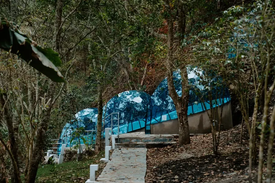Blue glamping domes among the trees at the Lucmabamba camp